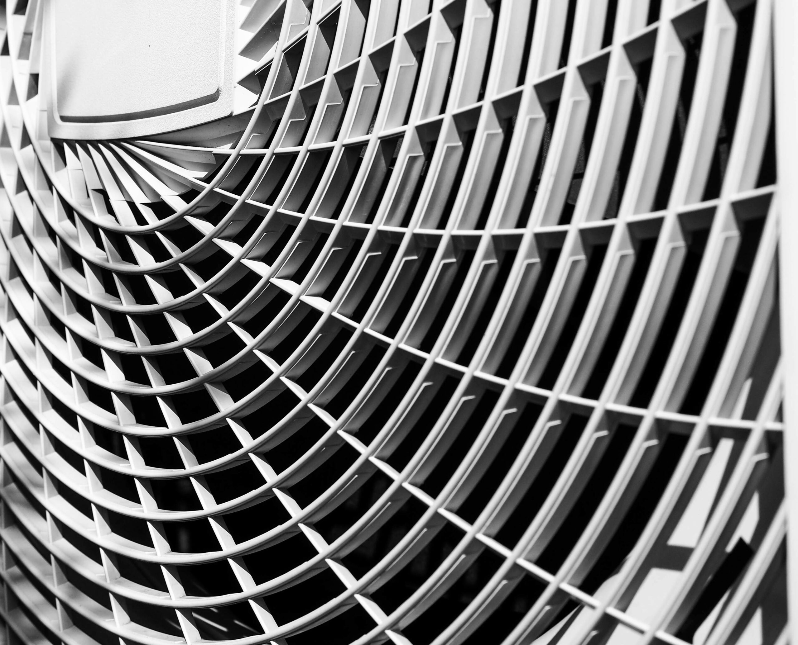 The inside of a cooling tower with a series of curved pipes attached to the circular inner wall