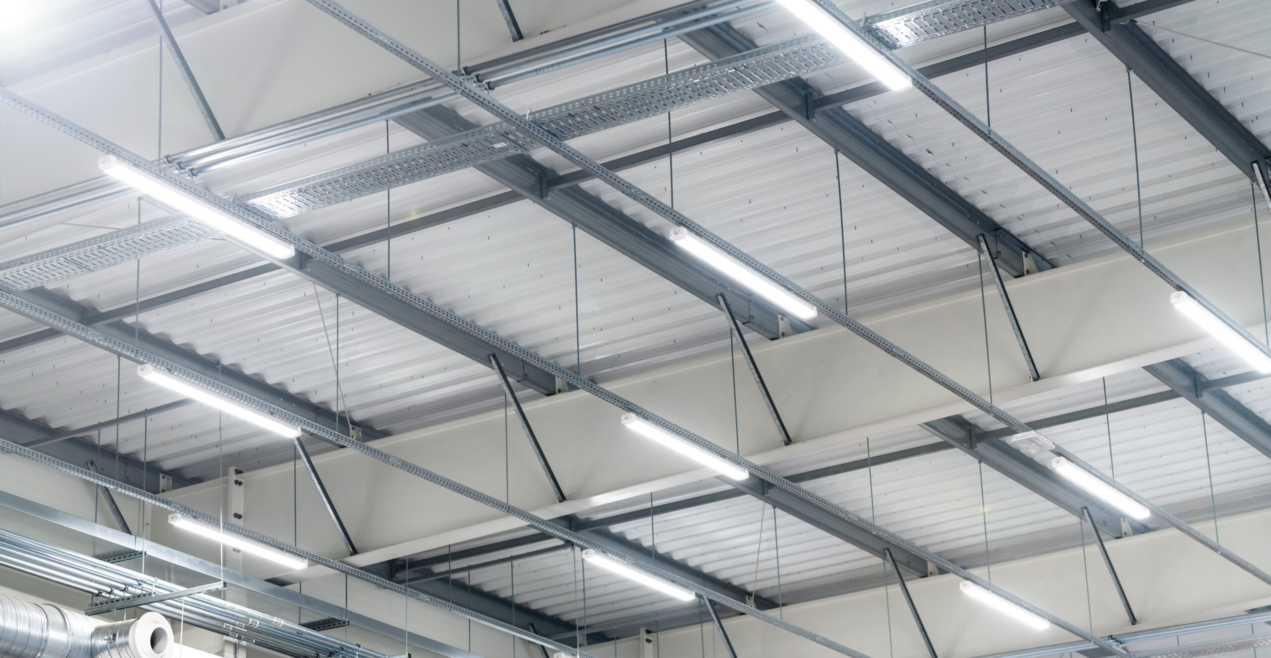 Energy-efficient LED light fittings under the roof of a large warehouse